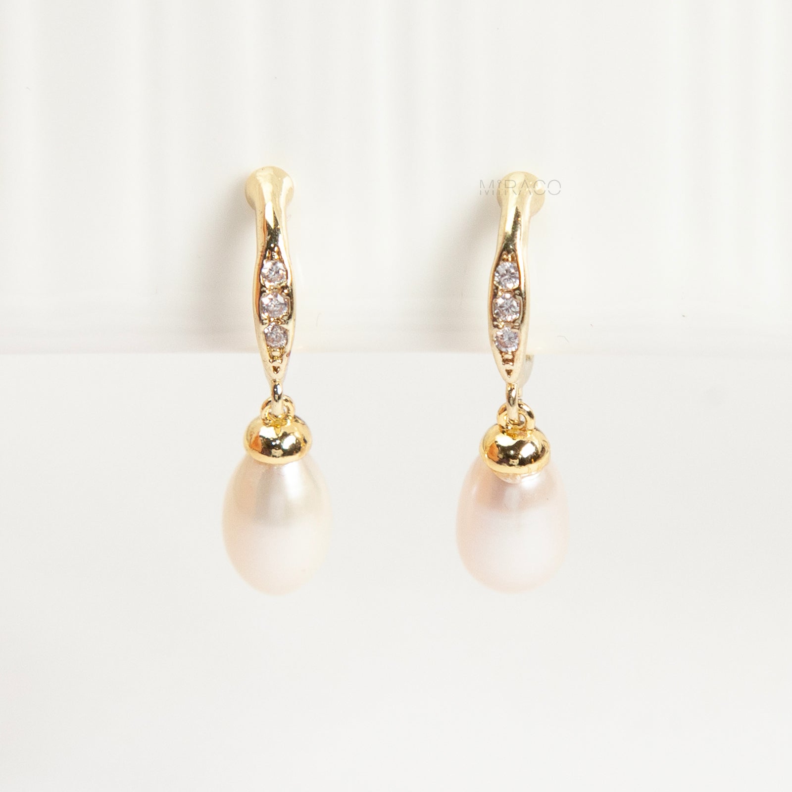 Pair of Sparkle Dangle Freshwater Pearl Clip-On Earrings with Coil Back and cubic zirconia accents.