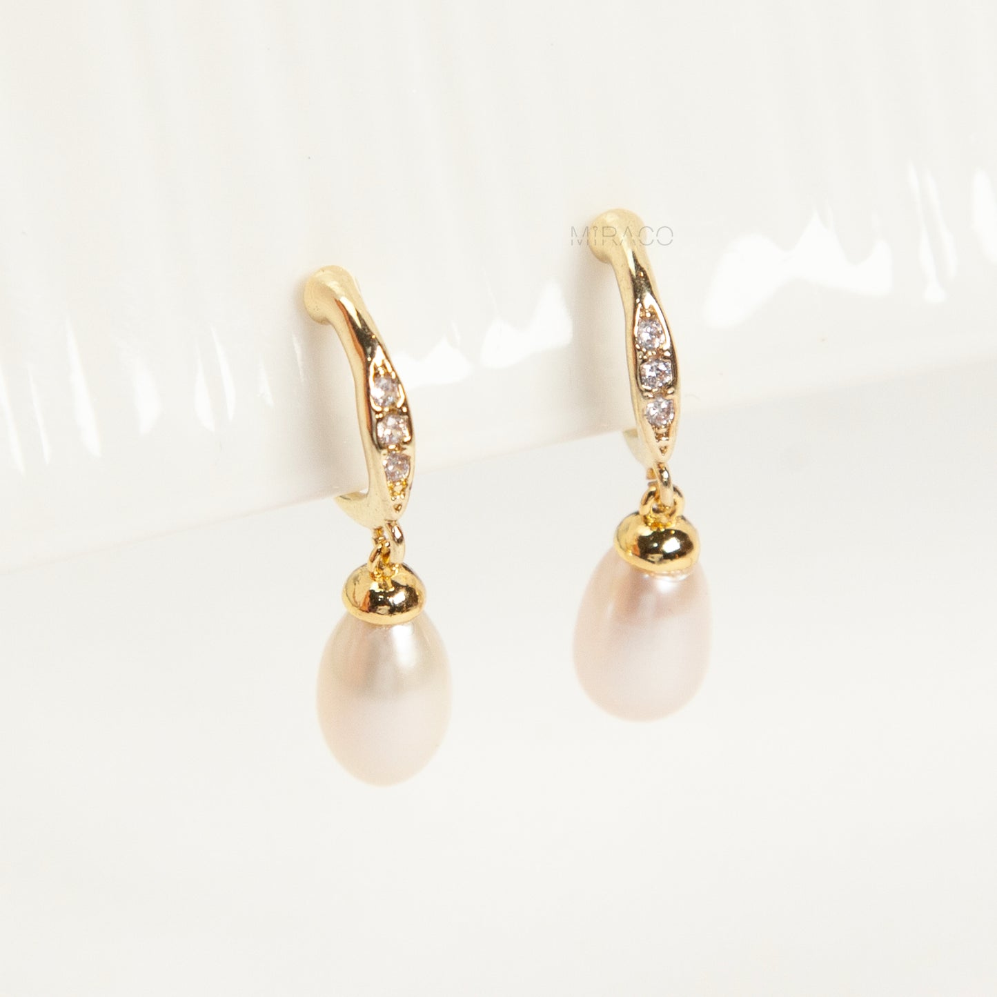 Pair of Sparkle Dangle Freshwater Pearl Clip-On Earrings with Coil Back and cubic zirconia accents.