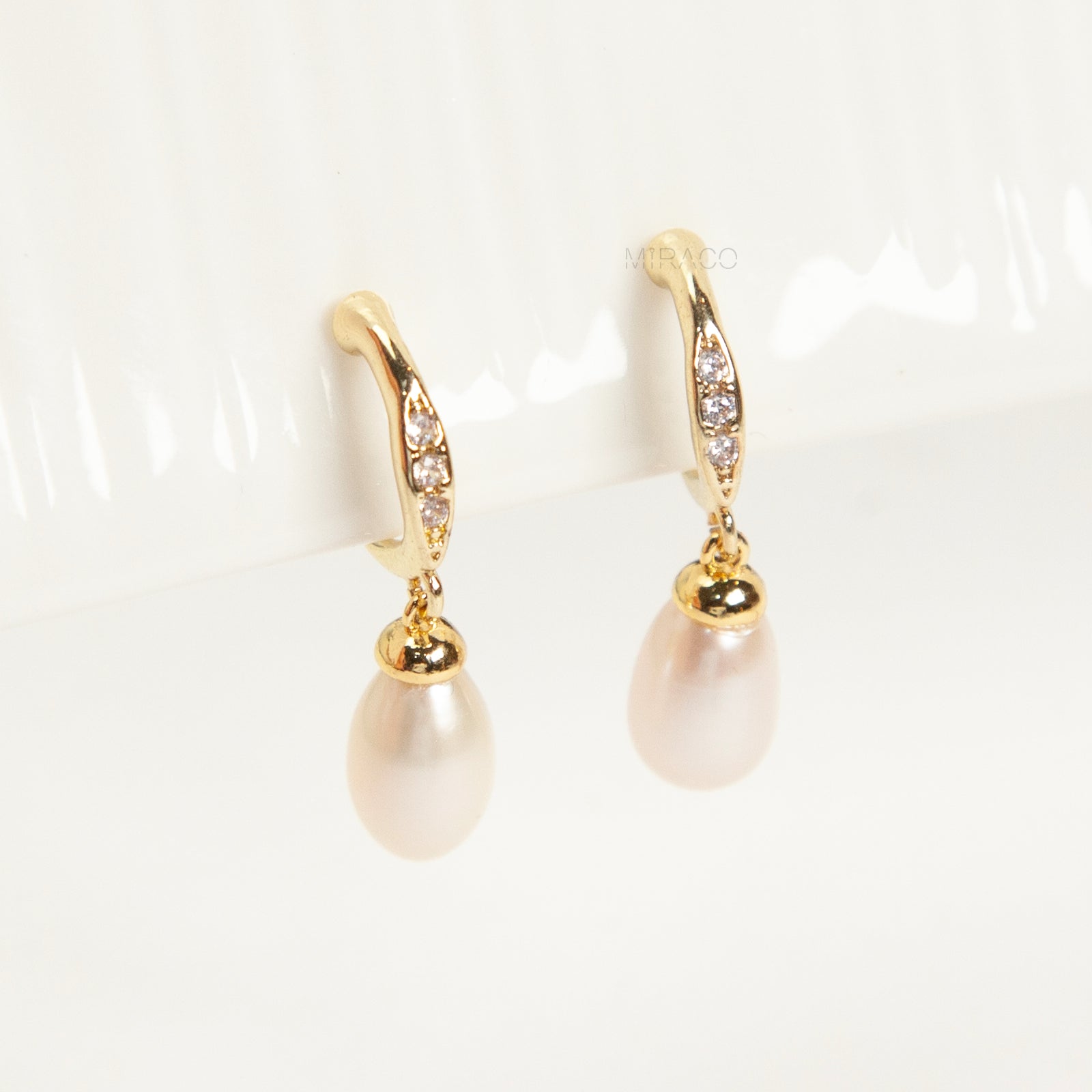 Pair of Sparkle Dangle Freshwater Pearl Clip-On Earrings with Coil Back and cubic zirconia accents.