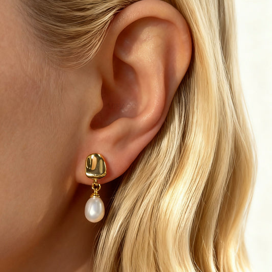 Pair of Gold-Tone Dangle Freshwater Pearl Clip-On Earrings with Coil Back closure.