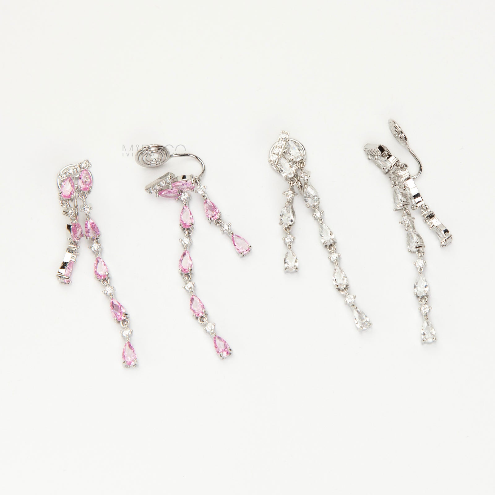 Long, silver-tone dangle clip-on earrings featuring cascading strands of clear (white) and pink pear-shaped and round-cut cubic zirconia stones.