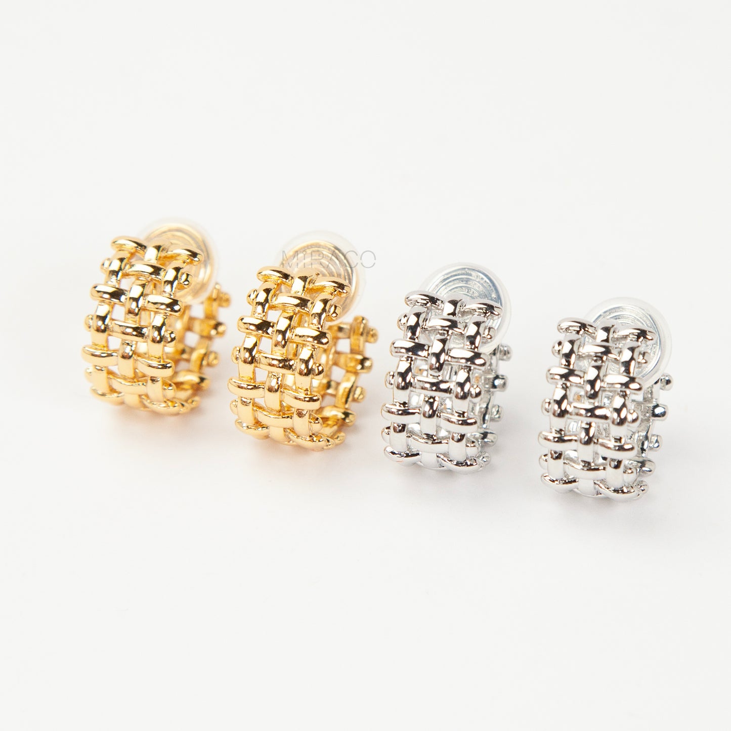 woven mesh coil back clip-on earrings on white background. Two are in silver tone and two are in gold tone. Shows the basketweave texture and the clear coil-back mechanism.