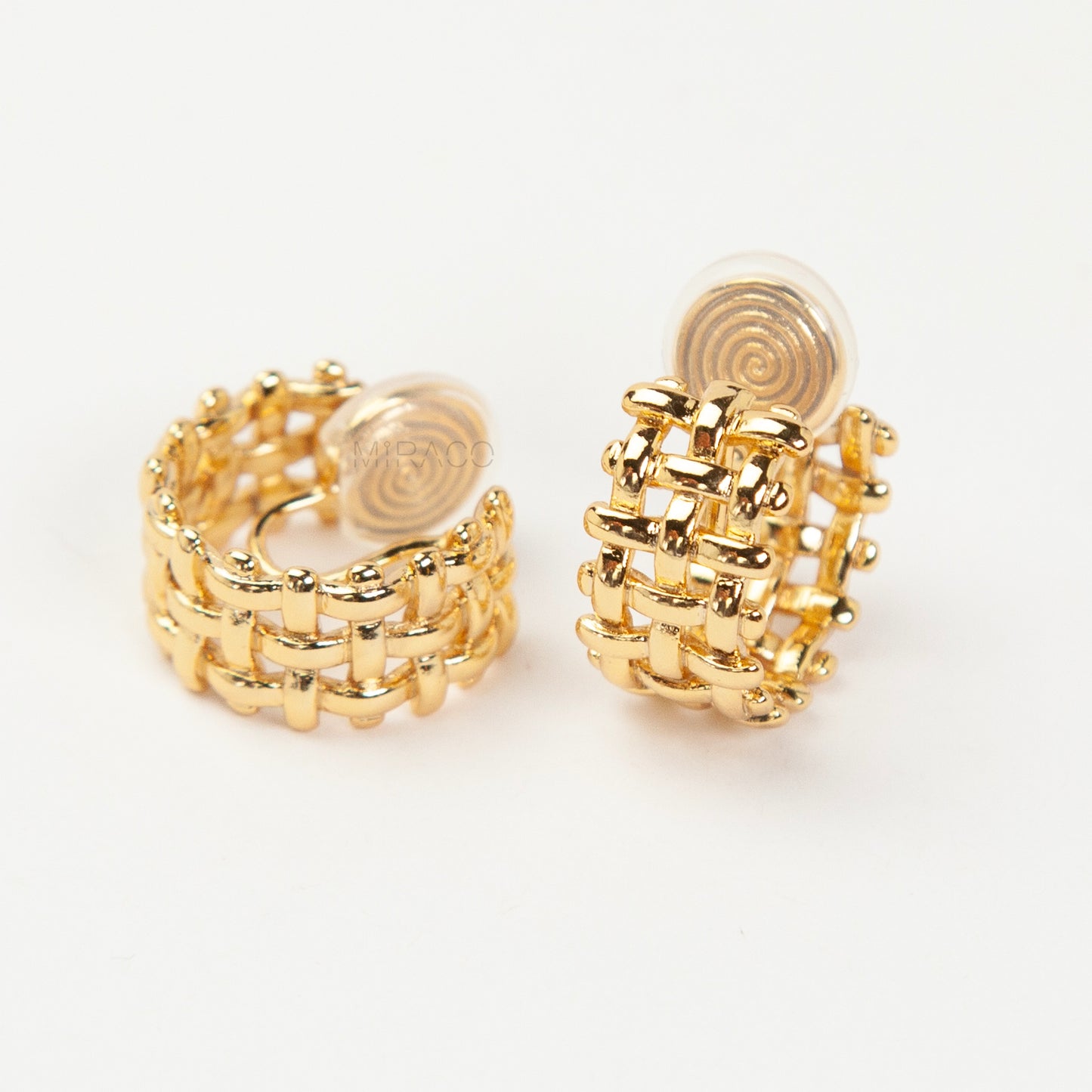 woven mesh coil back clip-on earrings on white background. Two are in silver tone and two are in gold tone. Shows the basketweave texture and the clear coil-back mechanism.