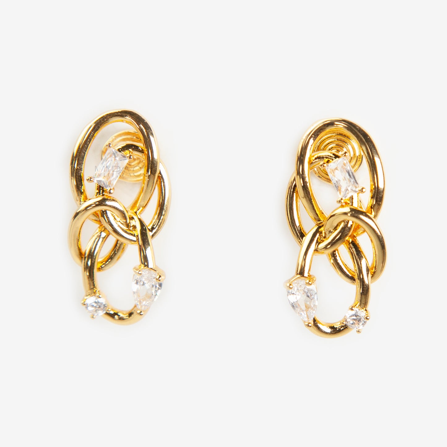 Close-up of a pair of gold interlocking double-knot clip-on earrings featuring two brilliant cut cubic zirconia stones, displayed on a white surface.