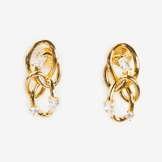 Close-up of a pair of gold interlocking double-knot clip-on earrings featuring two brilliant cut cubic zirconia stones, displayed on a white surface.