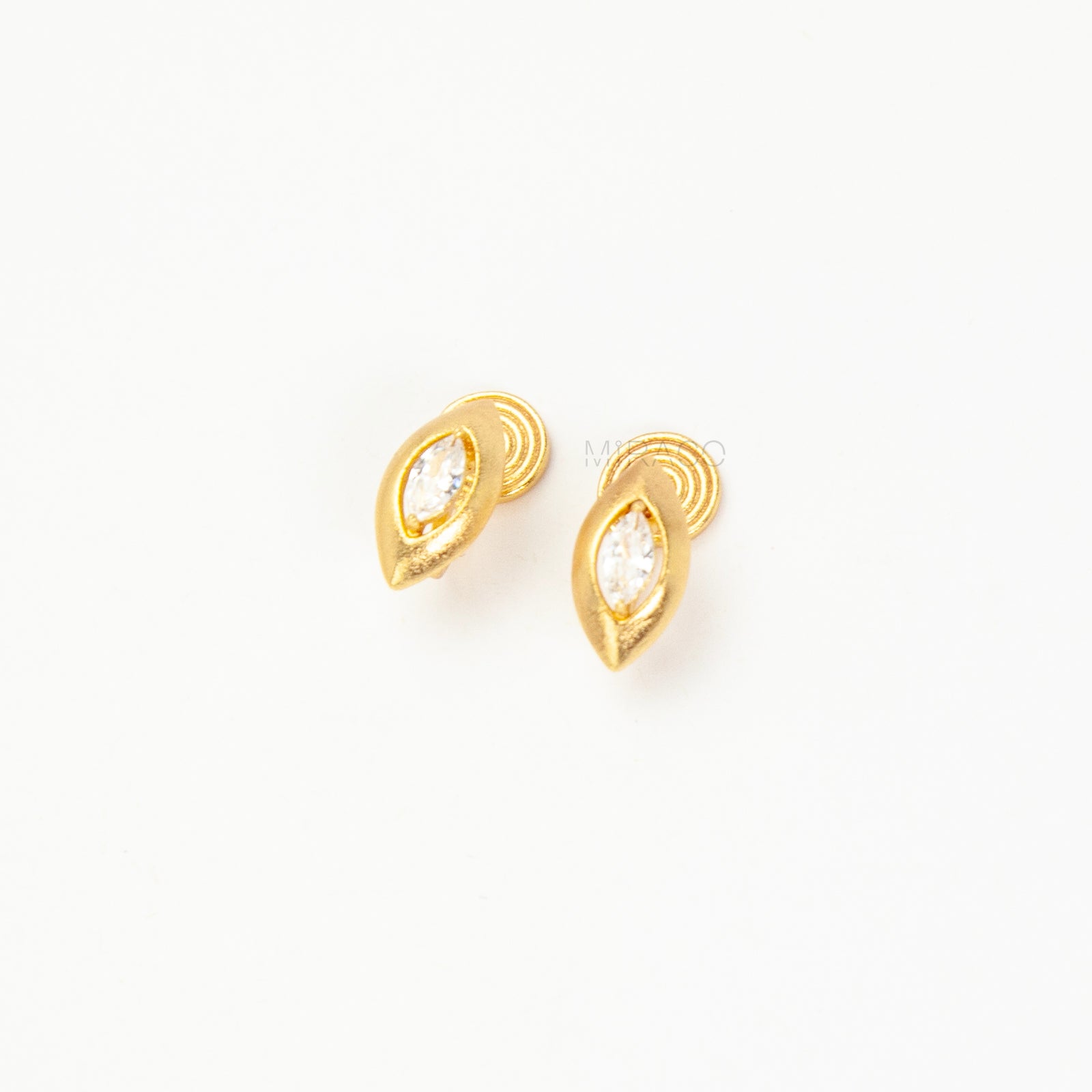 small gold-tone clip-on stud earring  featuring a marquise-cut clear gem.