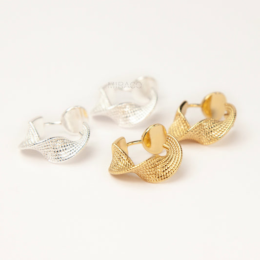 two pairs of small, twisted texture clip-on hoop earrings with a coil/screw back, one pair in gold tone and one in silver tone 