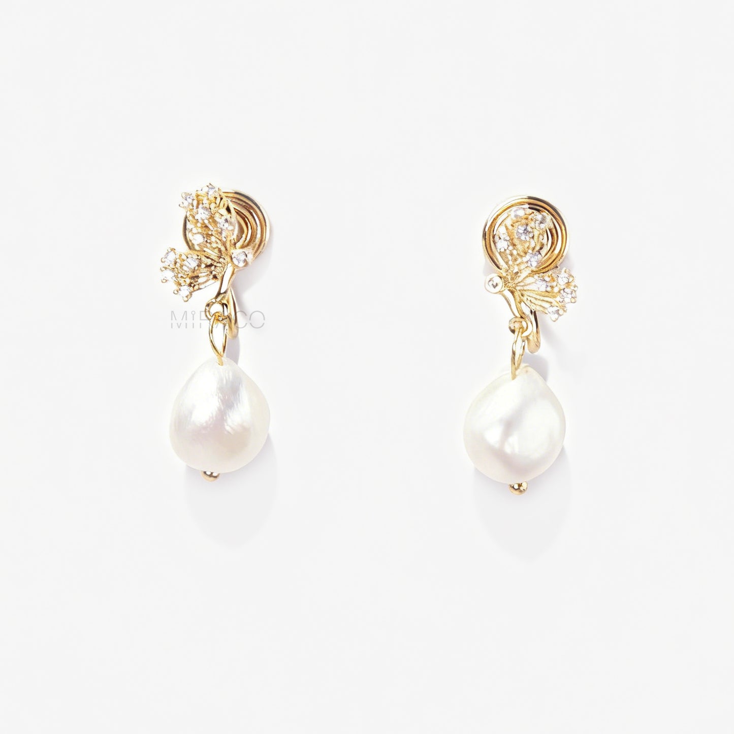 Pair of elegant gold-tone clip-on earrings with a CZ-encrusted butterfly swirl top and a dangling, lustrous white Baroque pearl drop, secured with a comfortable coil back clasp.