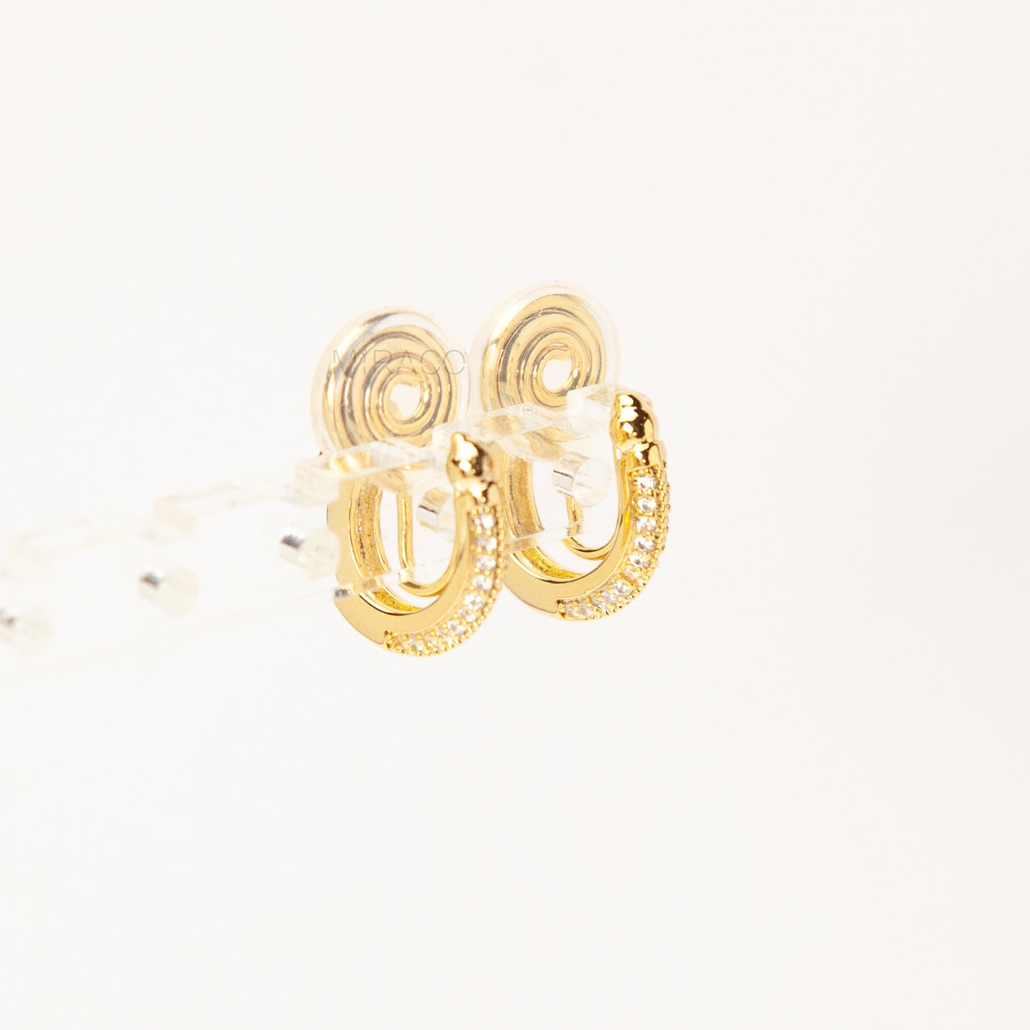 Gold clip-on hoop earrings with sparkling pave diamonds and coil back clips