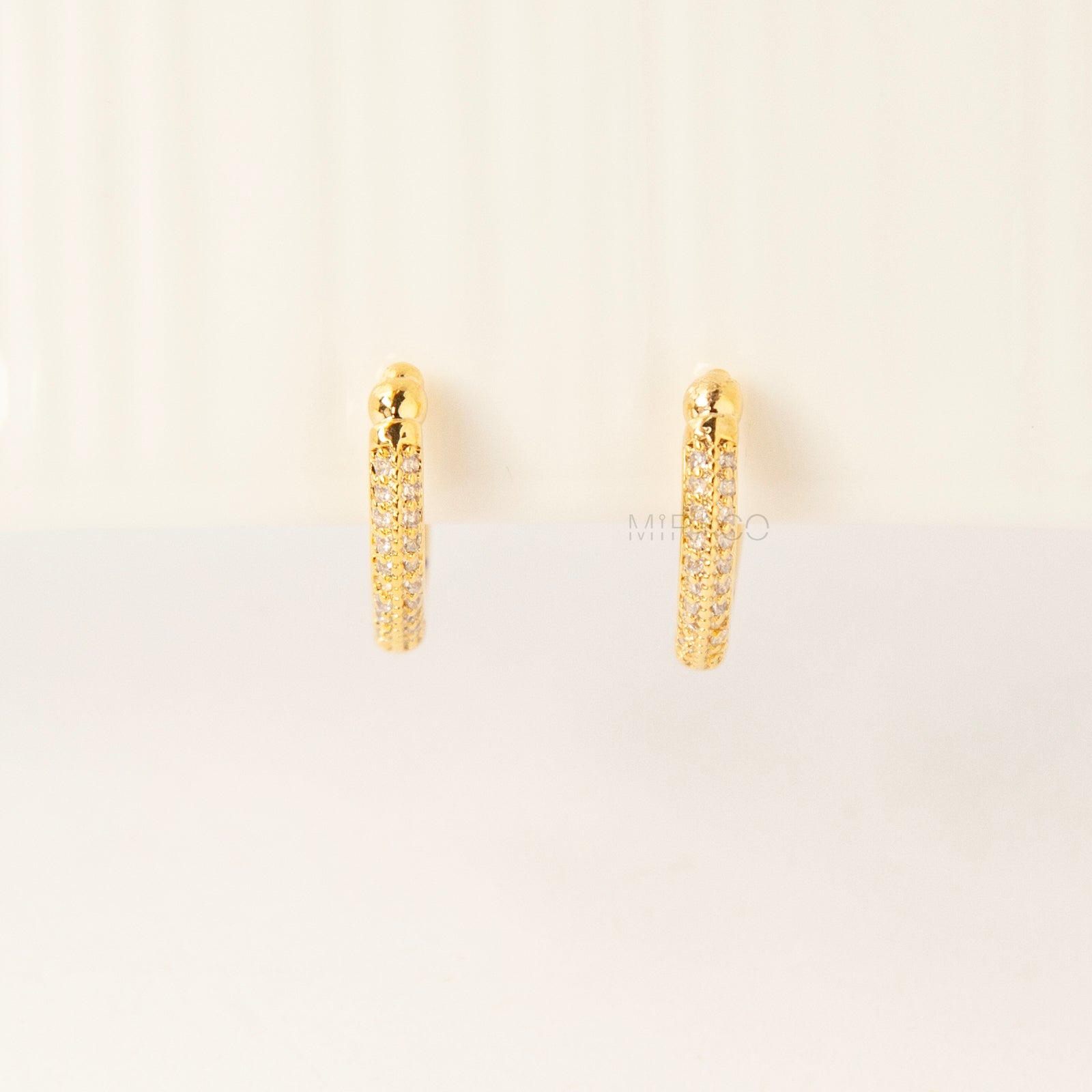 Gold clip-on hoop earrings with sparkling pave diamonds and coil back clips