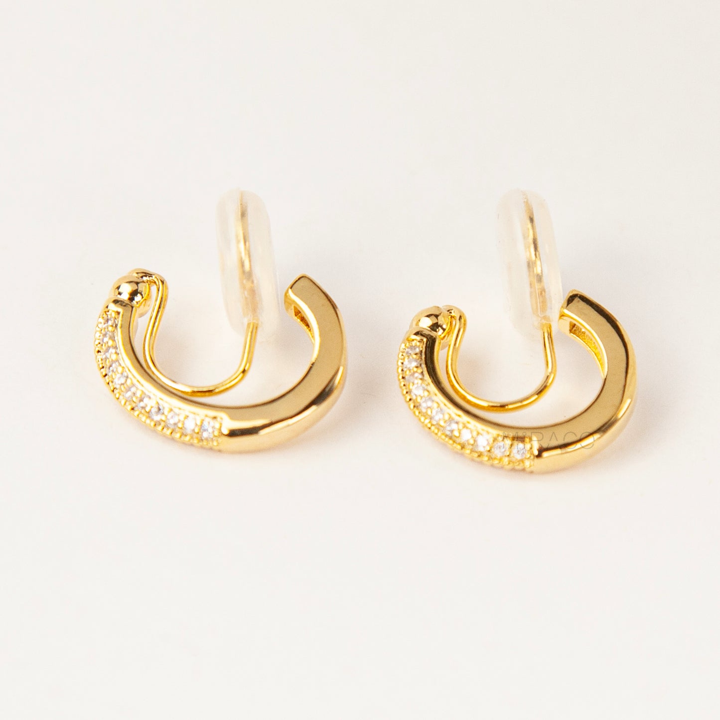 Gold clip-on hoop earrings with sparkling pave diamonds and coil back clips