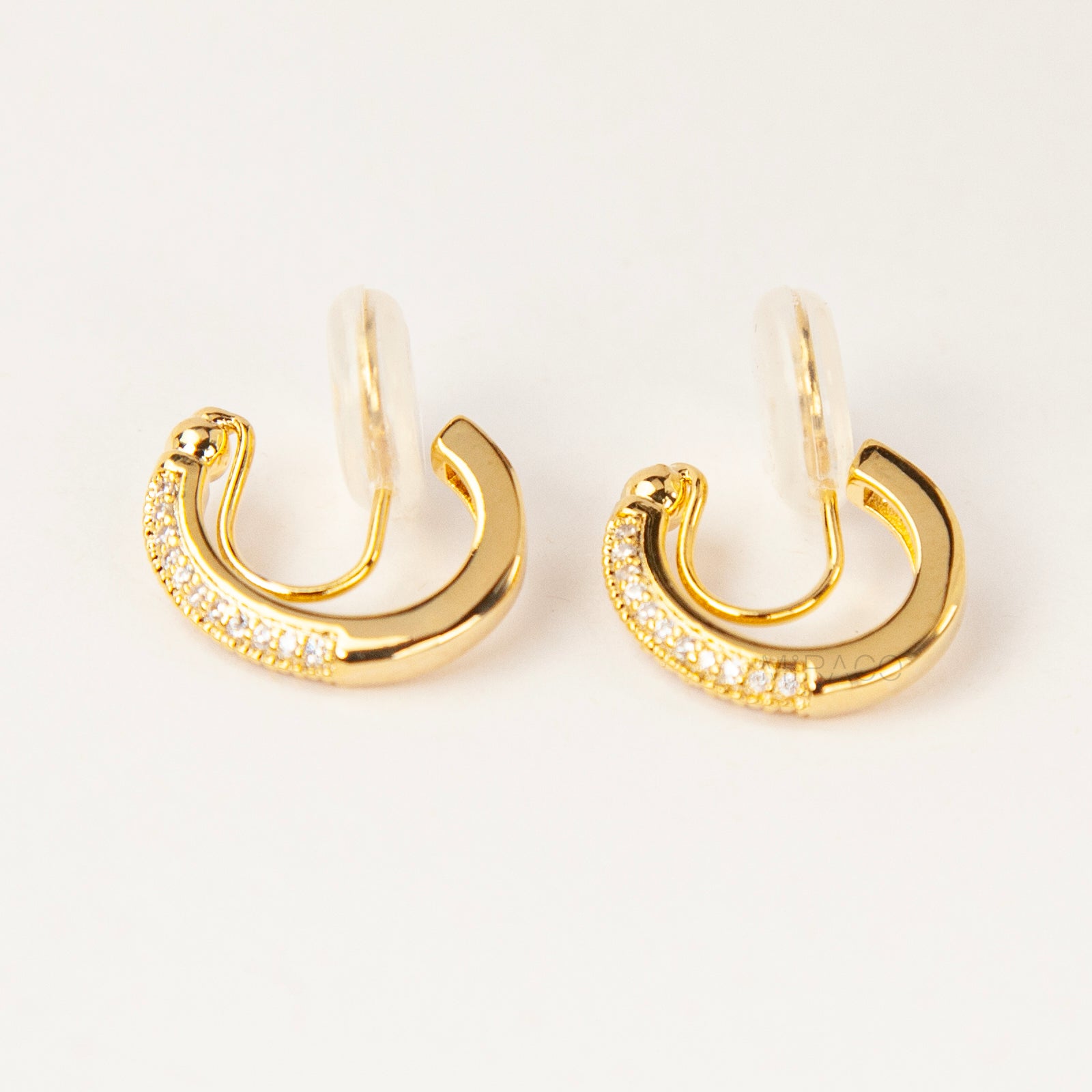 Gold clip-on hoop earrings with sparkling pave diamonds and coil back clips