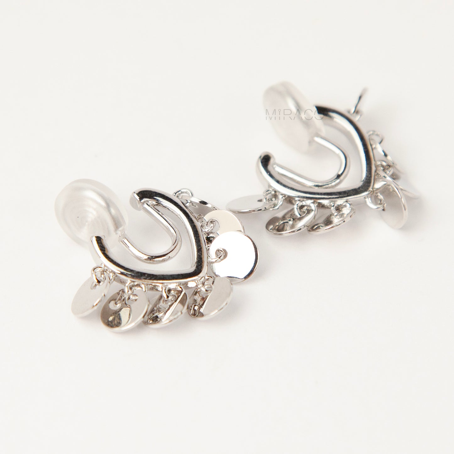 silver U-shaped clip-on earrings with dangling coin charms and comfortable coil back design for non-pierced ears