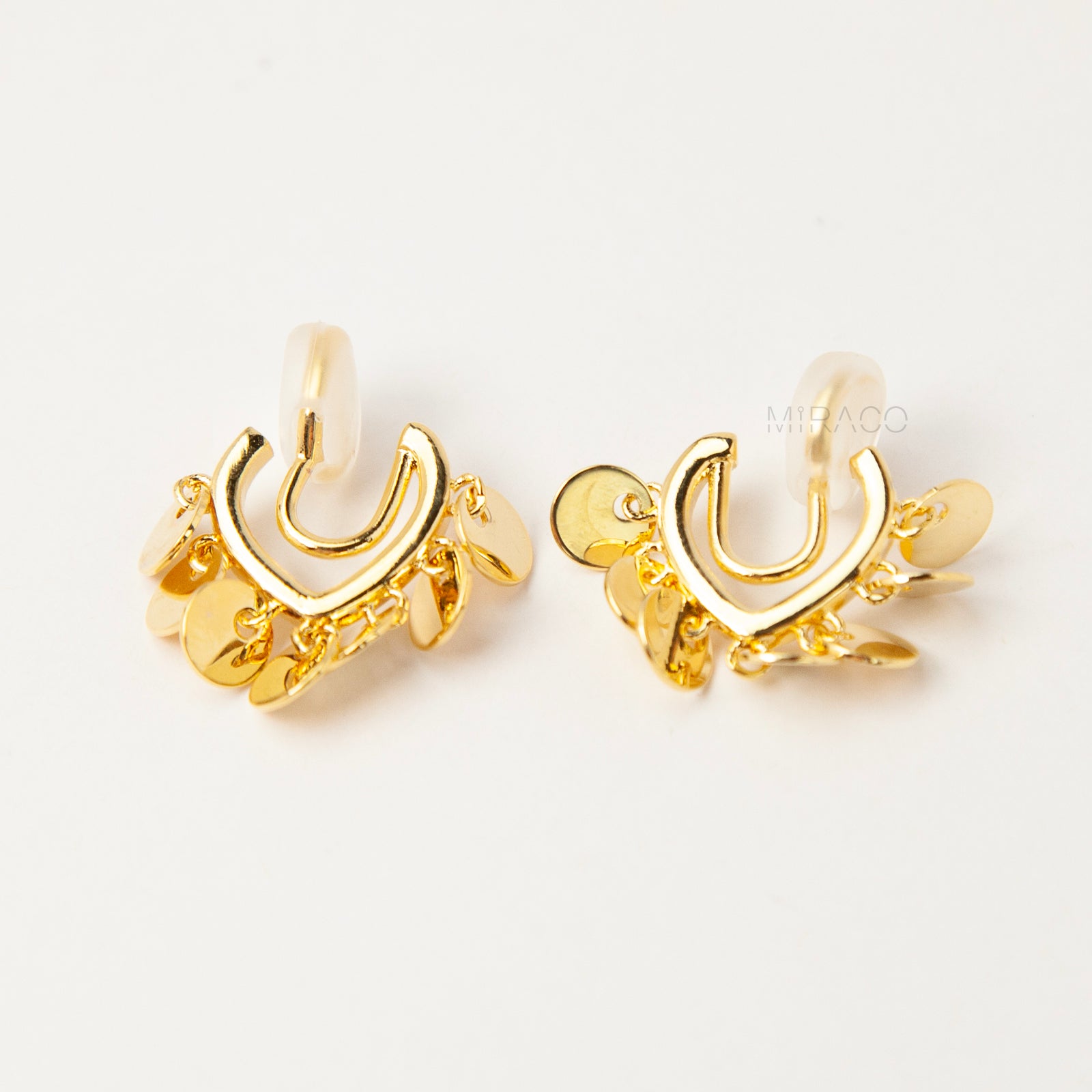 Gold U-shaped clip-on earrings with dangling coin charms and comfortable coil back design for non-pierced ears