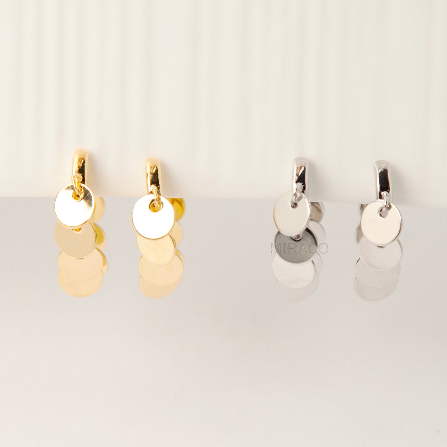 Gold and silver U-shaped clip-on earrings with dangling coin charms and comfortable coil back design for non-pierced ears
