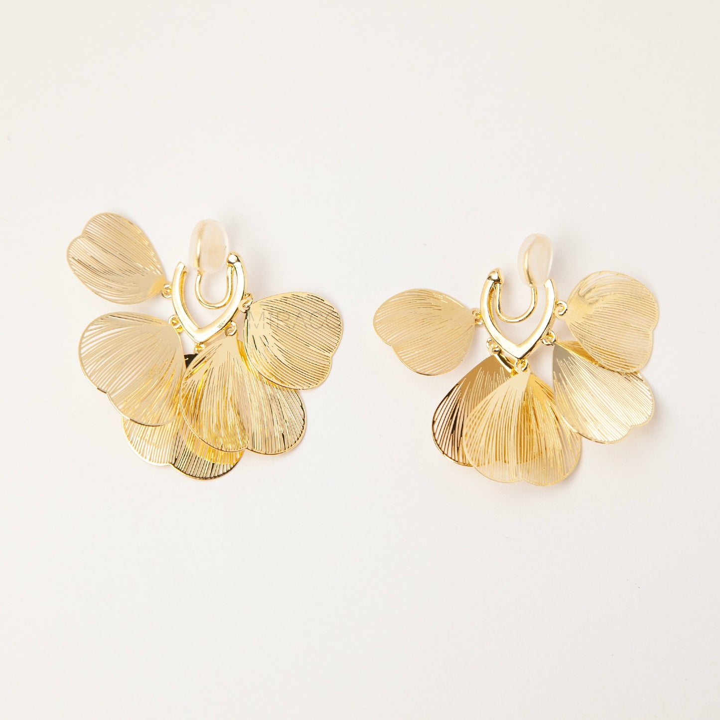 Gold layered petal clip-on earrings with textured fan-shaped charms and comfortable coil back for non-pierced ears
