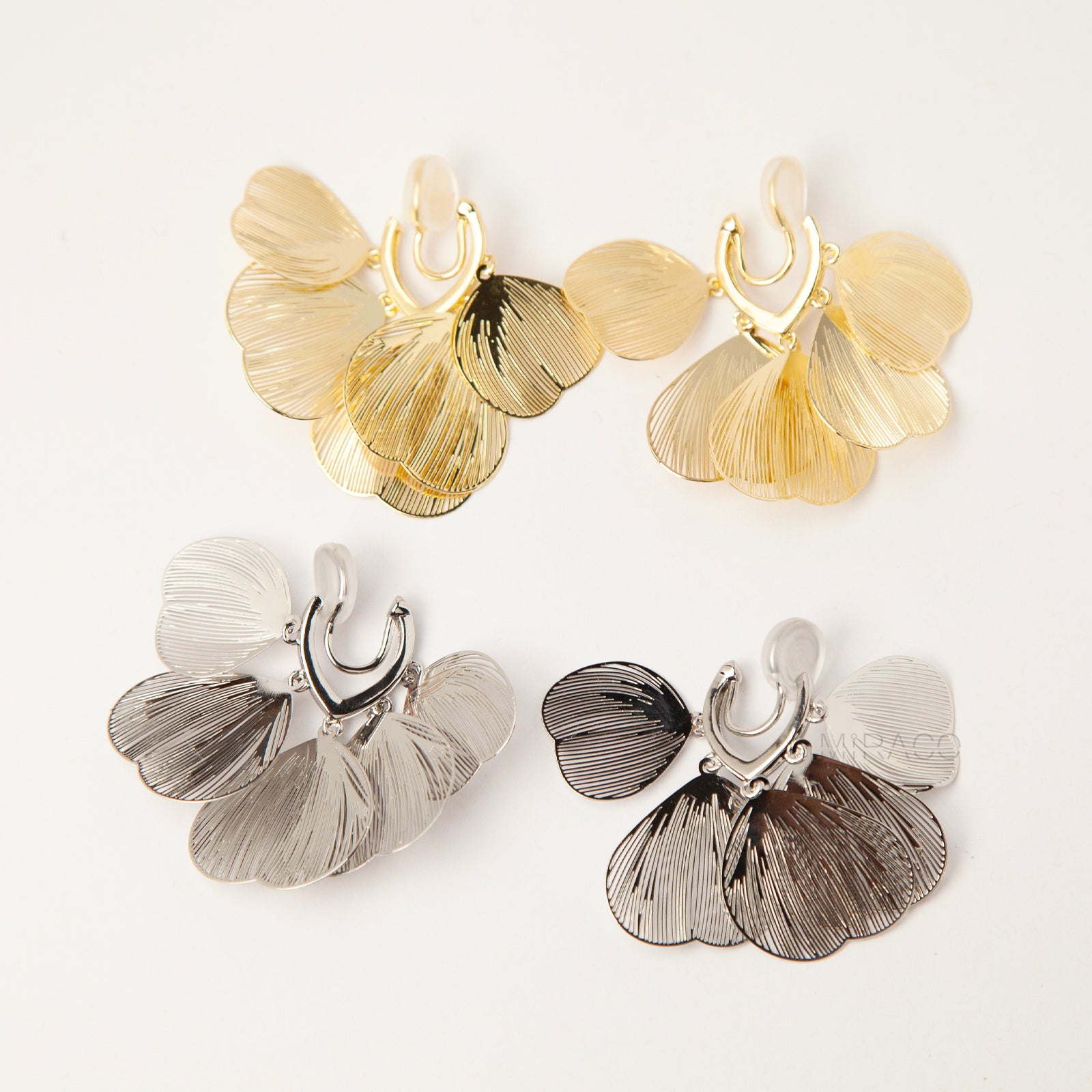 Gold and silver layered petal clip-on earrings with textured fan-shaped charms and comfortable coil back for non-pierced ears
