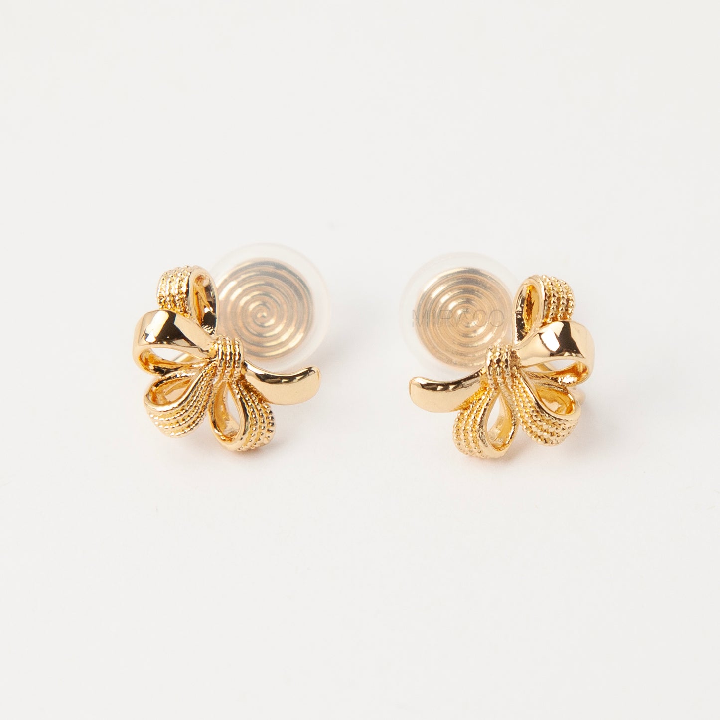 Pair of gold-tone multi-loop bow ribbon clip-on earrings featuring textured detailing and comfortable coil-back closures with clear silicone pads.