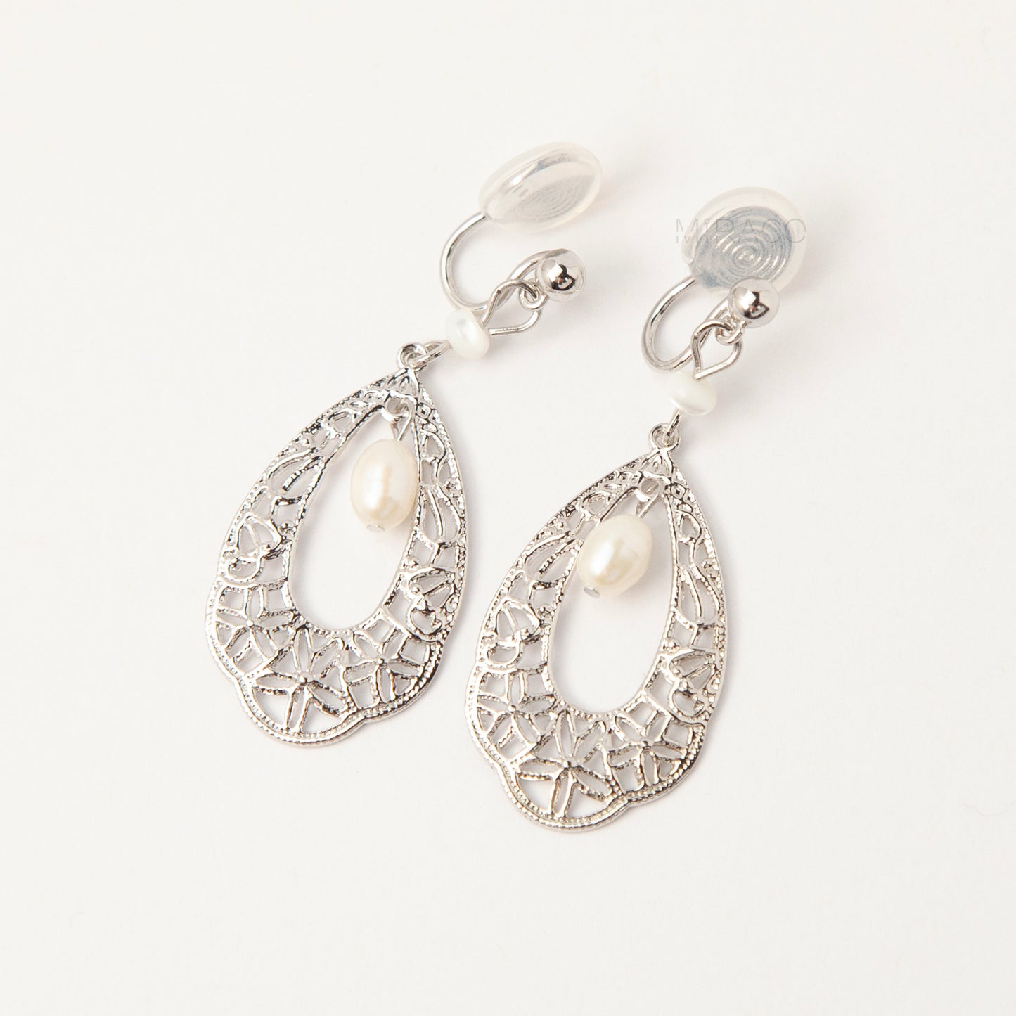 Silver filigree teardrop clip-on earrings with freshwater pearl drop and comfortable coil back for non-pierced ears