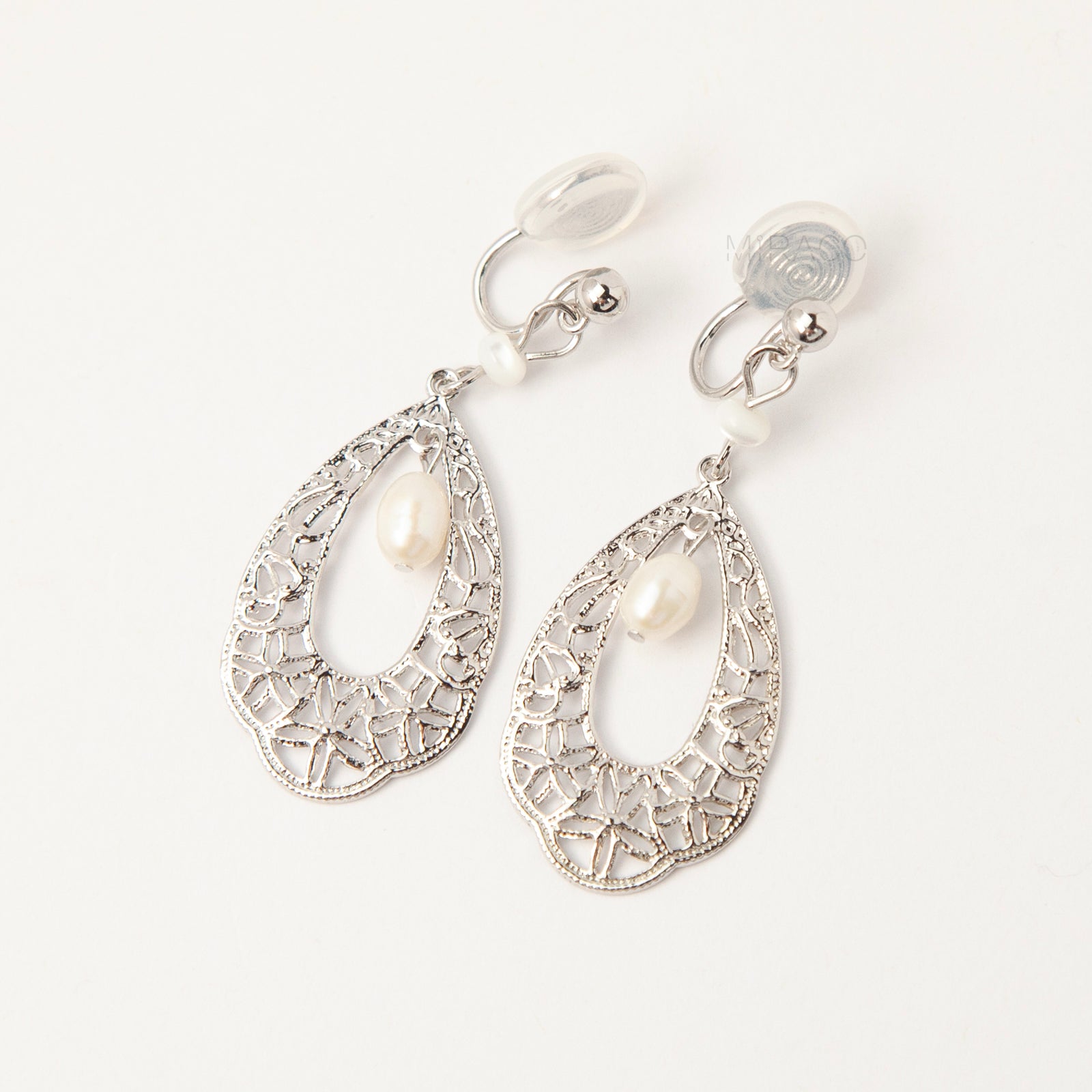 Silver filigree teardrop clip-on earrings with freshwater pearl drop and comfortable coil back for non-pierced ears