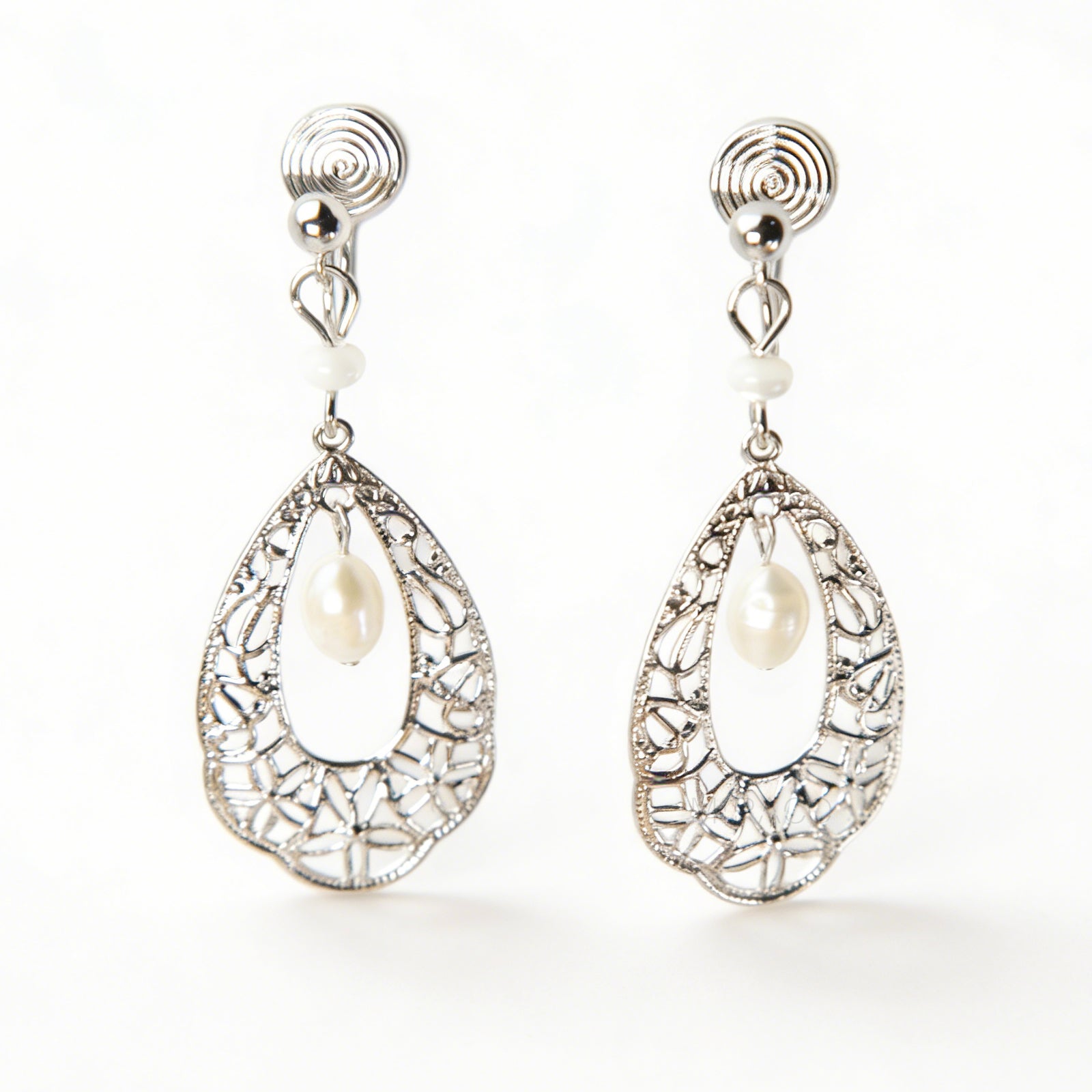 Silver filigree teardrop clip-on earrings with freshwater pearl drop and comfortable coil back for non-pierced ears