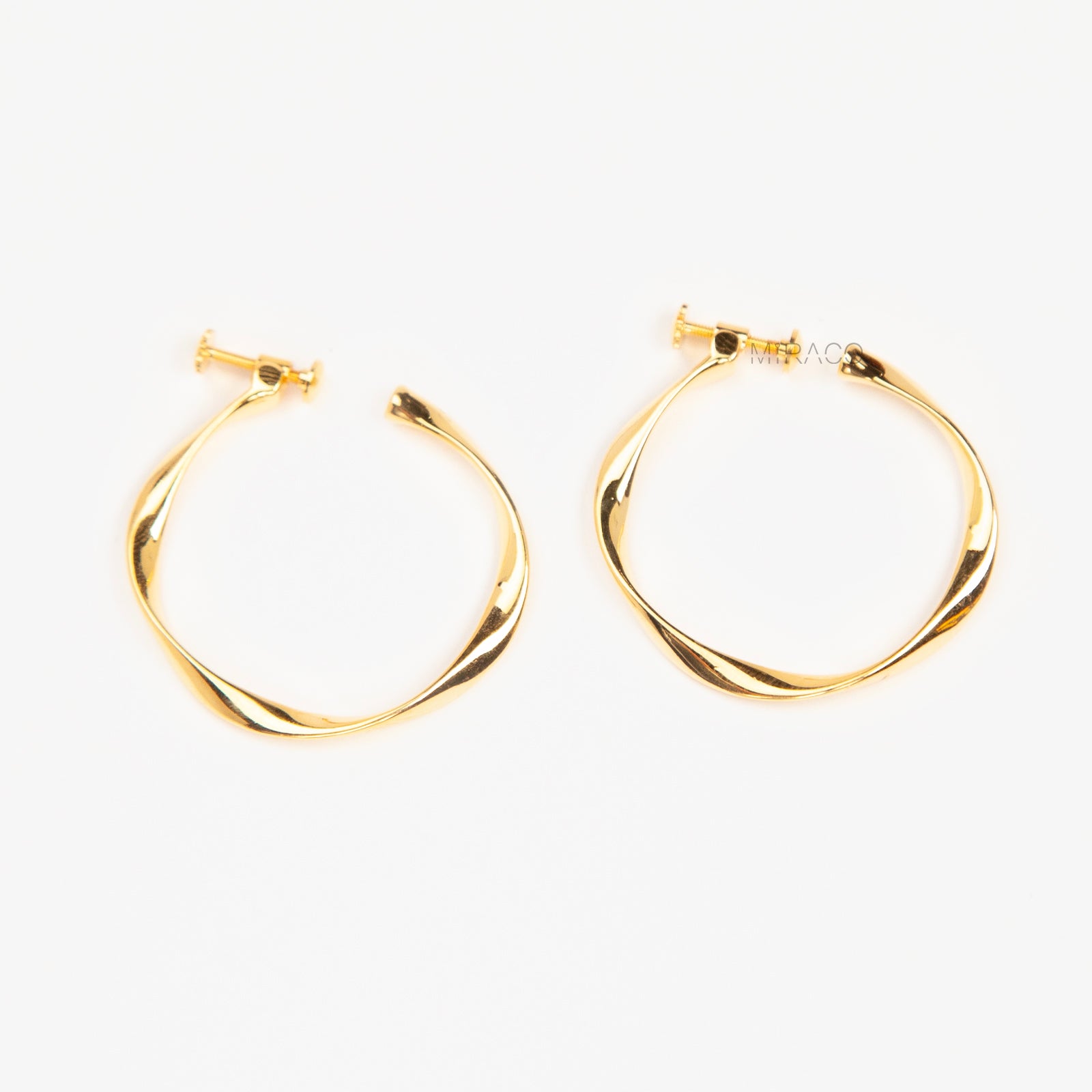 Pair of polished gold twisted hoop clip-on earrings with adjustable screw-back closures
