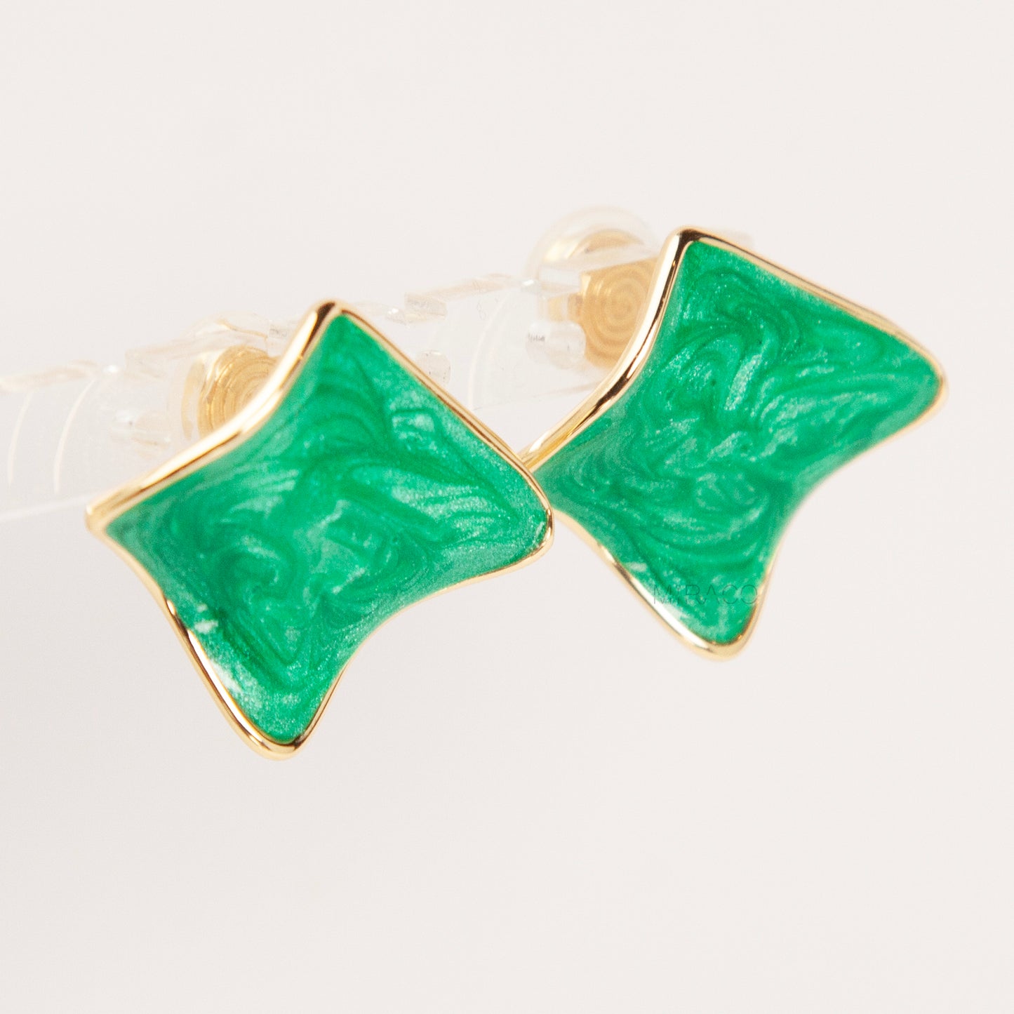 Pair of square-shaped emerald green marbled enamel clip-on earrings with gold-tone edges and comfortable coil back closures.