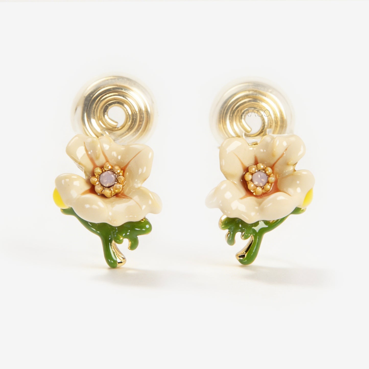 Pair of cream-colored enamel flower clip-on earrings with green stems and invisible gold-tone coil back closures on a white background.