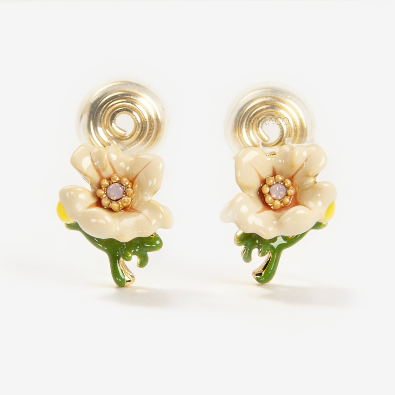 Pair of cream-colored enamel flower clip-on earrings with green stems and invisible gold-tone coil back closures on a white background.