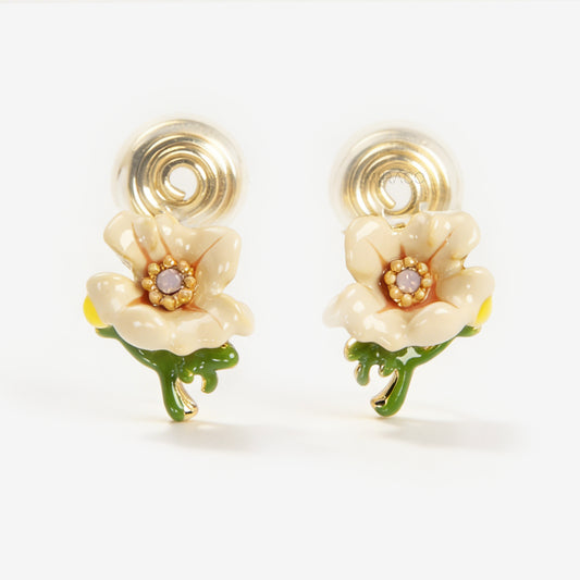 Pair of cream-colored enamel flower clip-on earrings with green stems and invisible gold-tone coil back closures on a white background.