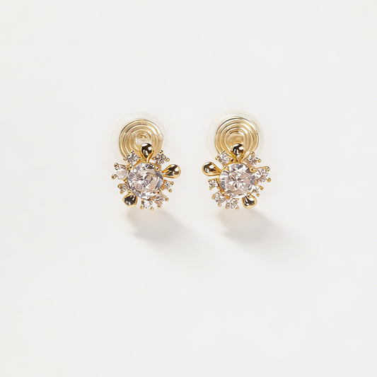 Pair of gold-tone sunburst-shaped clip-on earrings with a central cubic zirconia stone and comfortable invisible coil back closures.