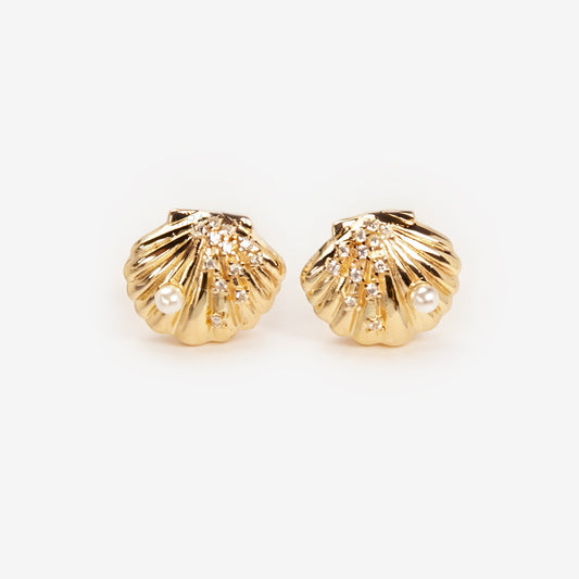 Pair of gold-tone scalloped seashell clip-on earrings featuring a small pearl and pavé crystals with comfortable invisible coil back closures.