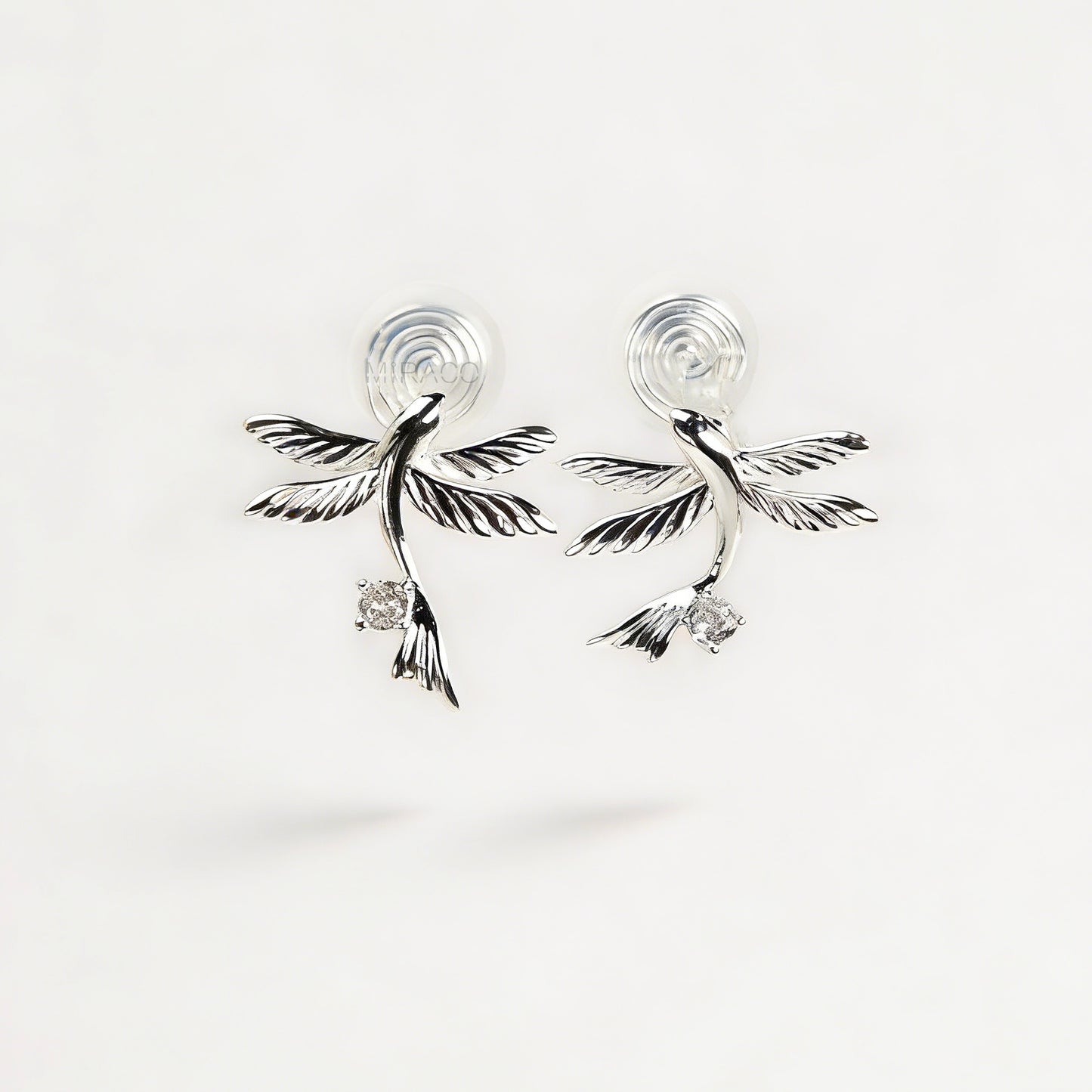 Pair of silver-tone bird-shaped clip-on earrings in flight with clear crystals and comfortable invisible coil back closures.