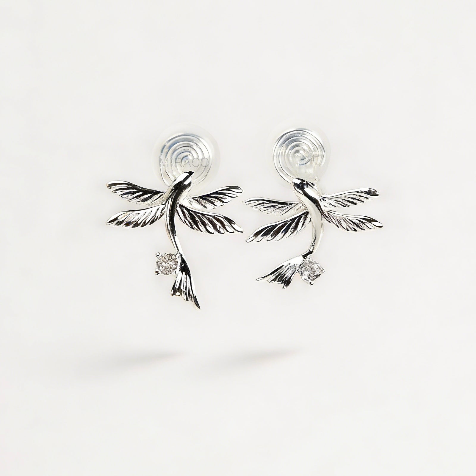 Pair of silver-tone bird-shaped clip-on earrings in flight with clear crystals and comfortable invisible coil back closures.