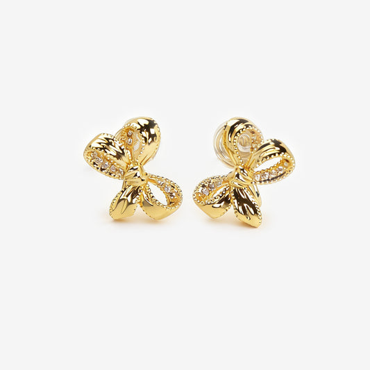 Pair of dainty gold-toned ribbon bow clip-on earrings with pave crystal details and a comfortable silver-tone coil back mechanism for non-pierced ears.