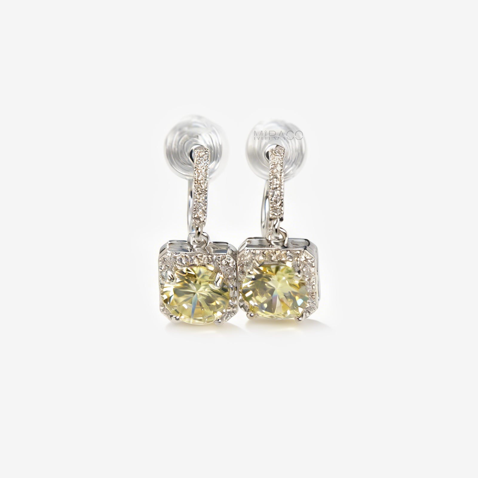 Front view of olive green crystal halo drop clip-on earrings with pave-set accents and clear silicone comfort pads for non-pierced ears.