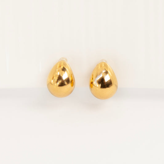 Pair of polished gold teardrop-shaped clip-on earrings with clear invisible resin backs.