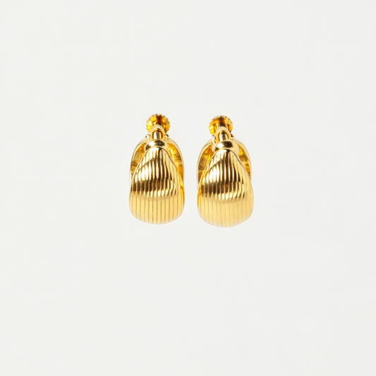 A pair of chunky, polished gold-tone dome clip-on earrings featuring a textured ribbed pattern and adjustable gold screw-back fasteners for non-pierced ears.