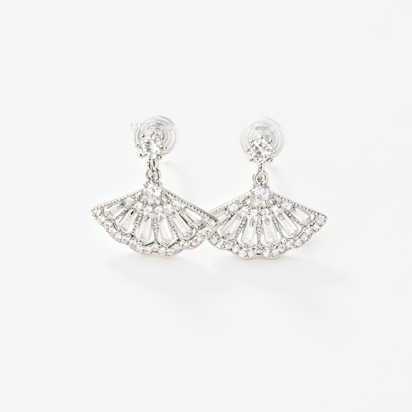 A pair of silver-tone Art Deco style clip-on drop earrings featuring a fan-shaped design set with baguette and round clear crystals, with adjustable coil-spring backs.