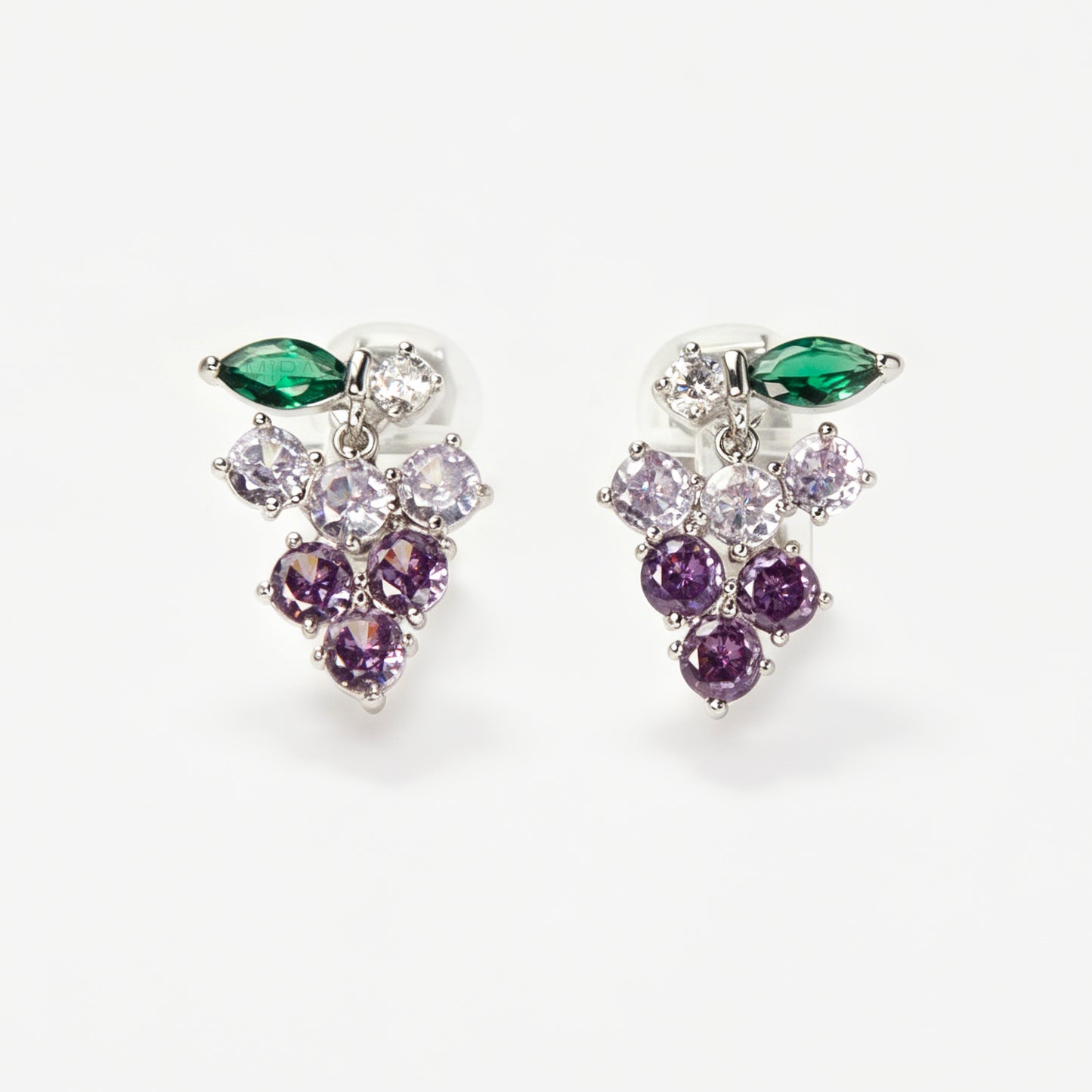 A pair of silver-tone clip-on earrings in the shape of a grape cluster, featuring various shades of round purple crystals and a green marquise-cut crystal leaf
