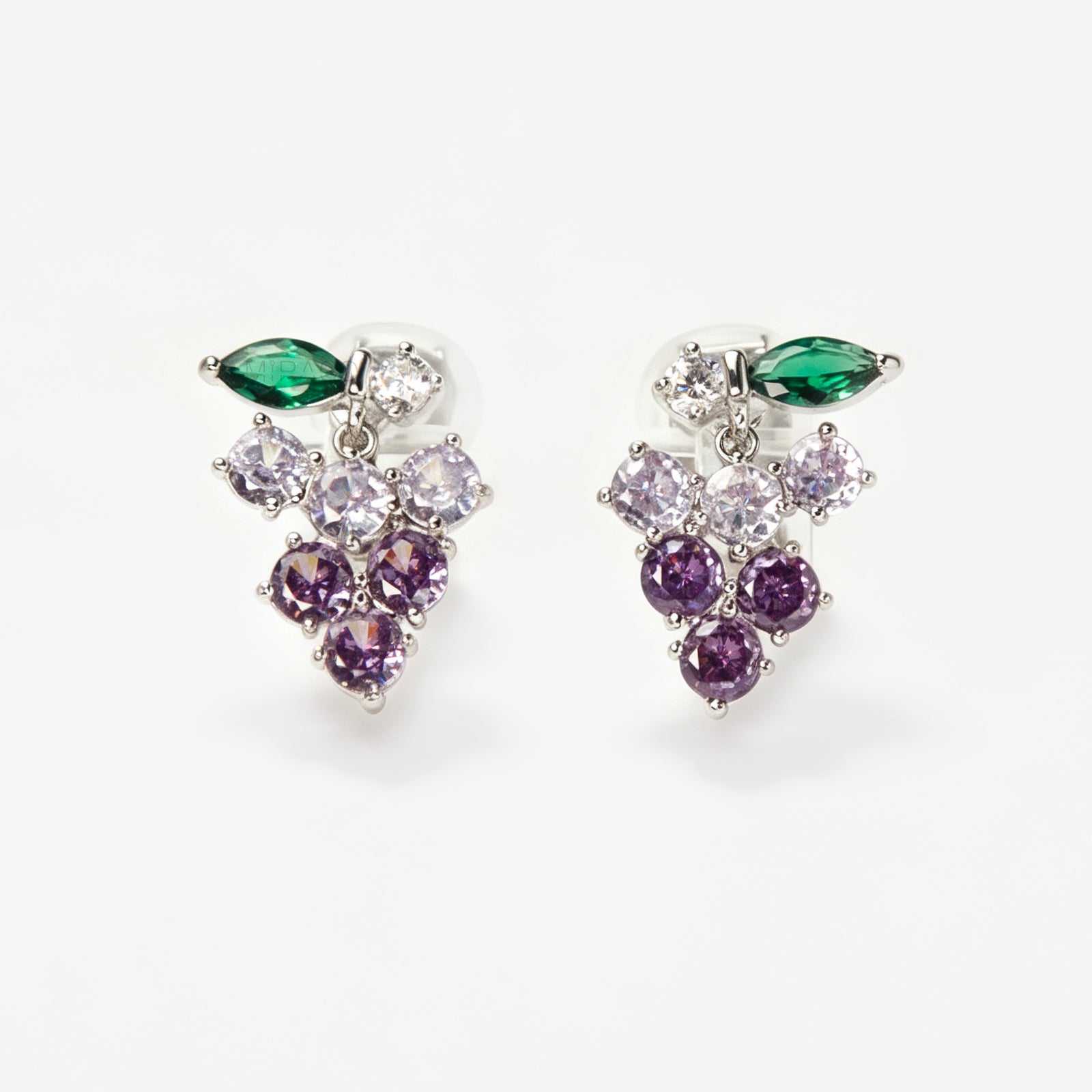 A pair of silver-tone clip-on earrings in the shape of a grape cluster, featuring various shades of round purple crystals and a green marquise-cut crystal leaf