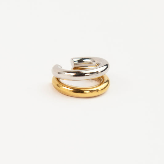 A minimalist two-tone double band ear cuff combining a polished silver hoop stacked with a gold hoop
