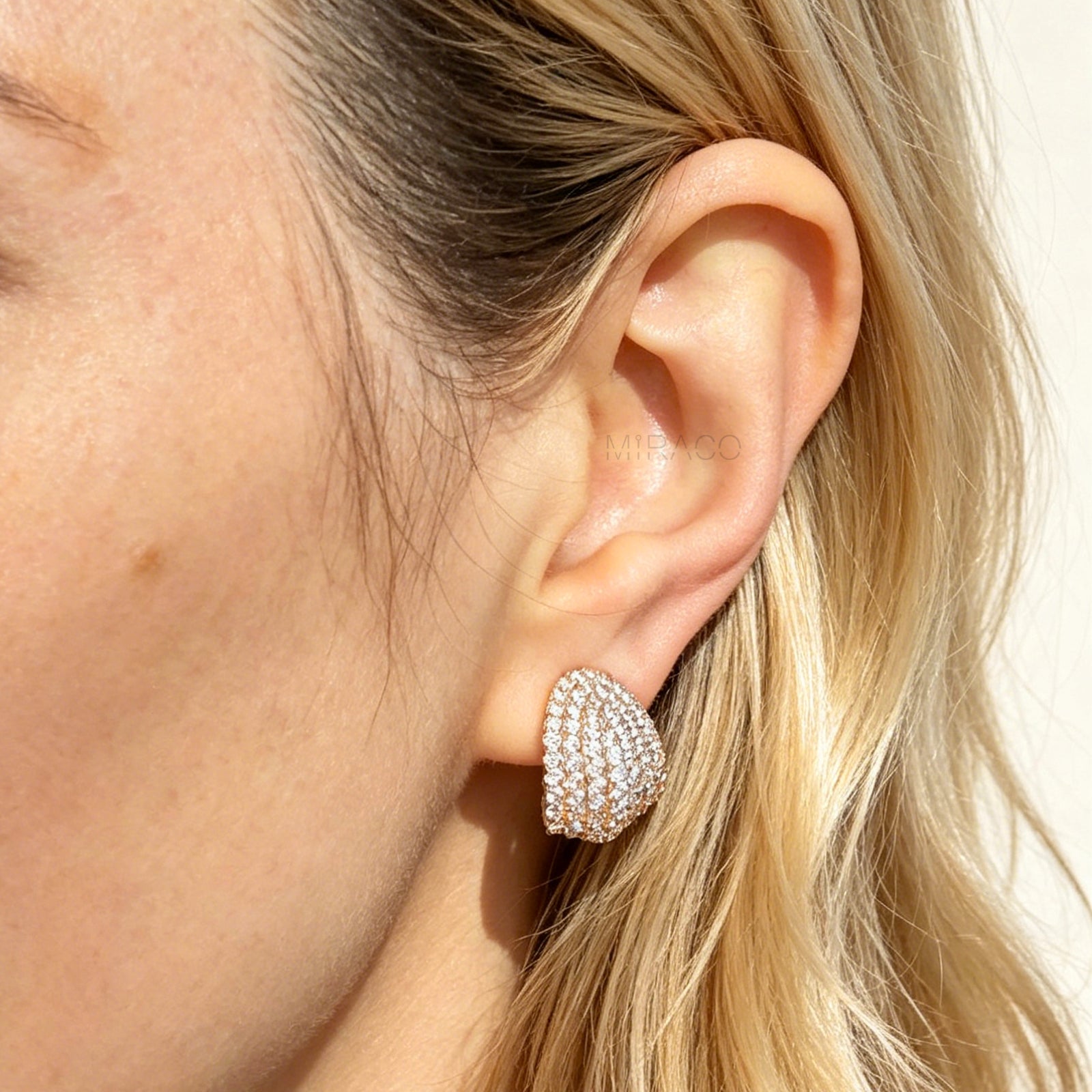 elegant gold plated pave CZ dome clip-on earrings. Features sparkling cubic zirconia and pain-free adjustable coil backs for non-pierced comfort.