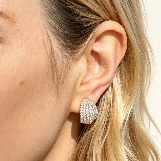 elegant gold plated pave CZ dome clip-on earrings. Features sparkling cubic zirconia and pain-free adjustable coil backs for non-pierced comfort.