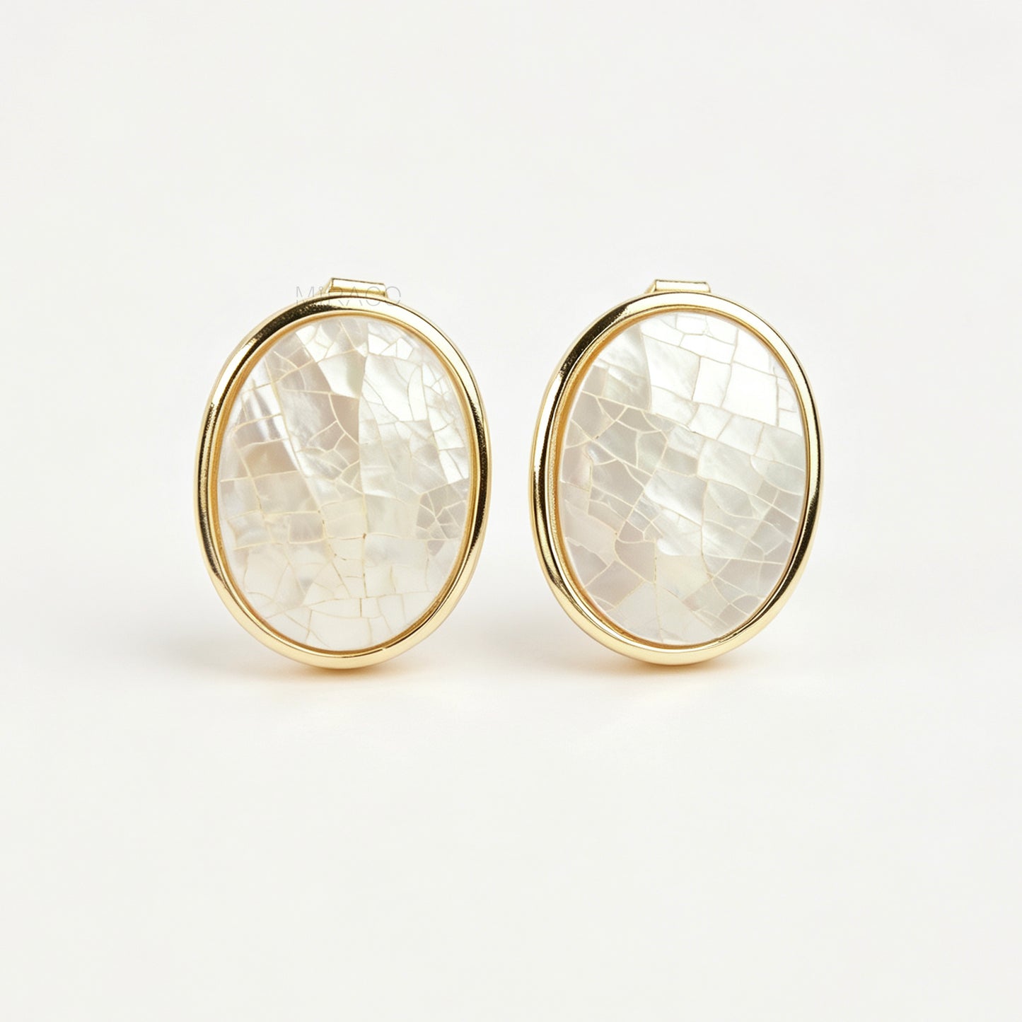 Pair of oval gold-tone non-pierced clip-on earrings with mini clip backs, set with iridescent white mother of pearl shell mosaic inlay.