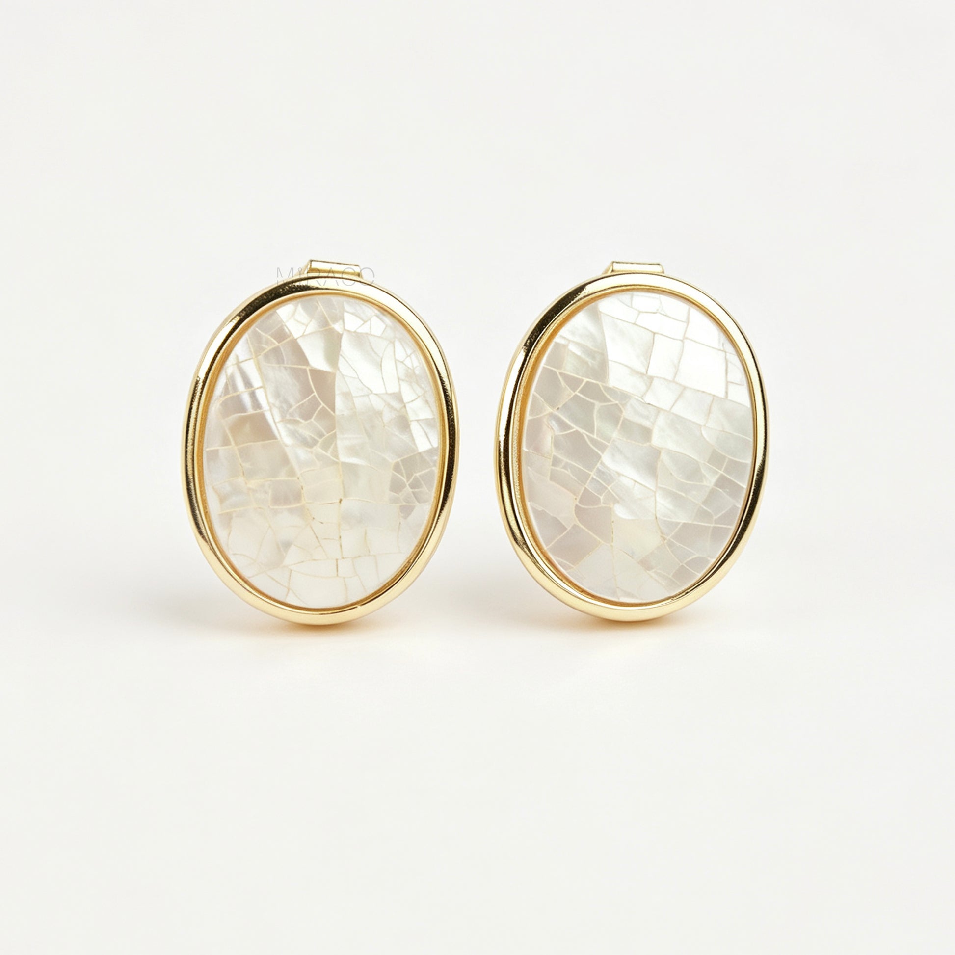 Pair of oval gold-tone non-pierced clip-on earrings with mini clip backs, set with iridescent white mother of pearl shell mosaic inlay.