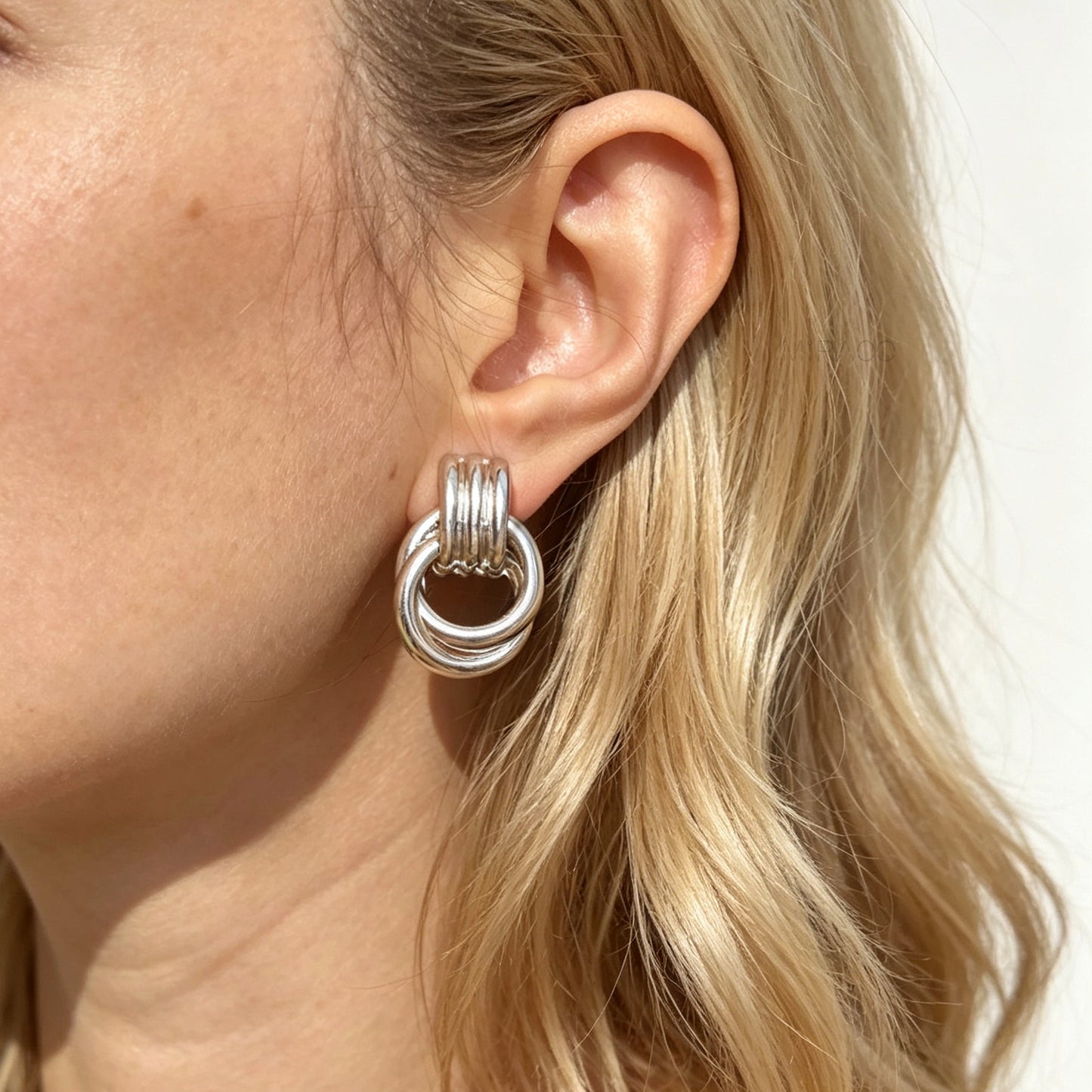 Gold and silver non-pierced double ring door knocker clip-on earrings with ribbed texture tops and mini clip backs displayed side by side.
