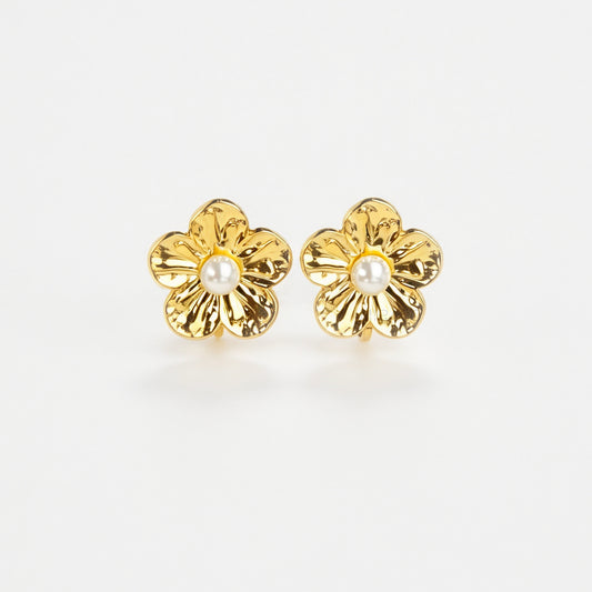 Pair of gold-toned non-pierced flower clip-on stud earrings with textured petals, white faux pearl center, and paddle back clip mechanism.