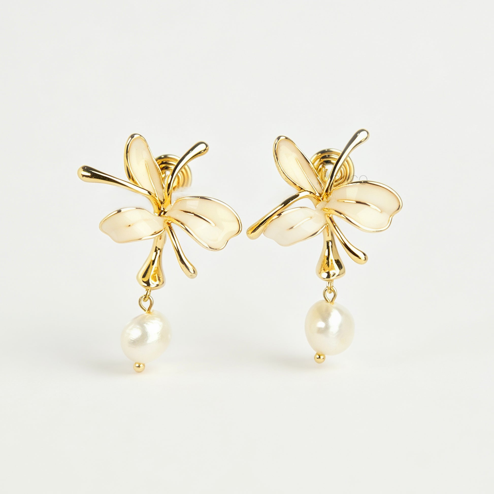 Pair of gold-toned non-pierced clip-on earrings featuring cream enamel floral petals with dangling genuine freshwater pearls and spiral coil backs.