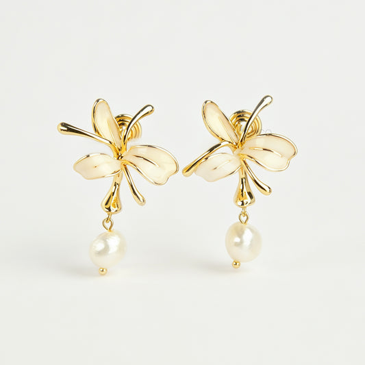 Pair of gold-toned non-pierced clip-on earrings featuring cream enamel floral petals with dangling genuine freshwater pearls and spiral coil backs.